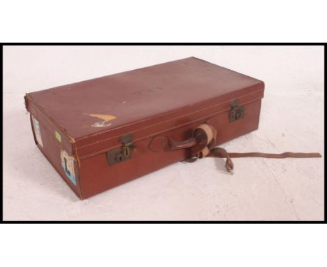 A vintage leather travel suitcase, embossed for AEL to top, along with a leather artists sketch pad. H39xW71xD20cm