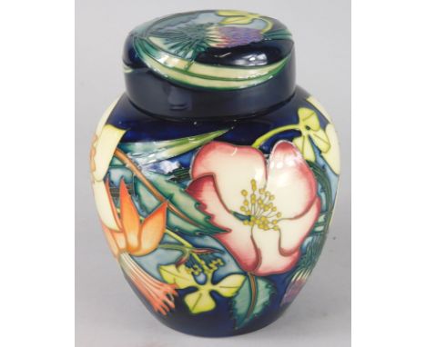 A Moorcroft Elizabeth II Golden Jubilee ginger jar and cover, decorated with flowers on a blue ground, copyright 2001 to unde