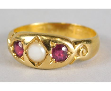 A 22ct gold ruby and pearl set gypsy ring, with central pearl (AF), flanked by two dark red rubies, with scroll design should