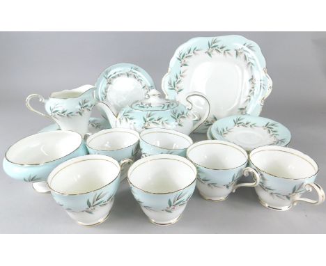 An Aynsley part tea service, decorated with a design of leaves and berries, on a pale blue ground