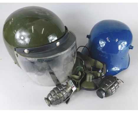 An army type motorcycle helmet, stamped B1, a replica type tin helmet etc.