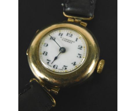 An A Corbett wristwatch, with circular watch head, with white enamel dial, and black hands, with black strap, yellow metal, u