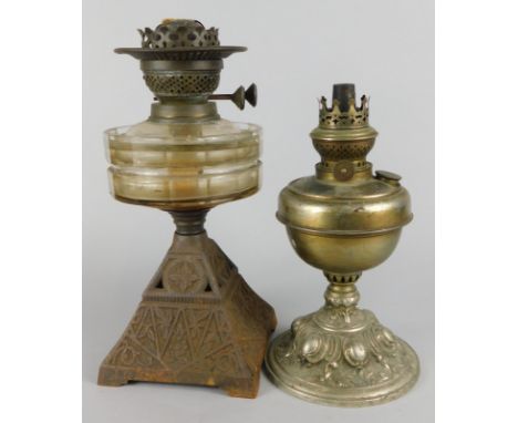 A Victorian cast iron and clear glass oil lamp, and a silver plated oil lamp (2)