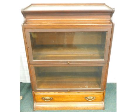 An early 20thC oak Globe Wernicke style two section bookcase, with a plinth base (AF and adapted), 87cm wide