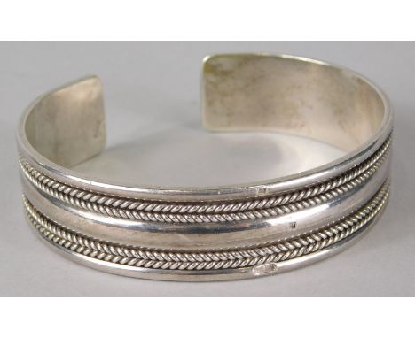 An Egyptian silver bangle, with four row reeded design