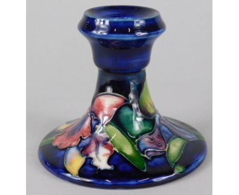 A Moorcroft pottery dwarf candlestick, with tube line decoration of irises, 10cm high