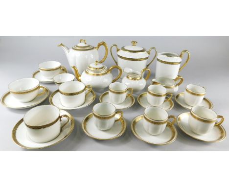 A Limoges porcelain part tea and coffee service, decorated with a gilt Greek key band, various marks to underside, to include