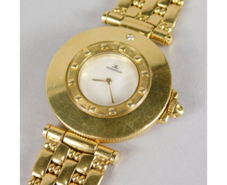 A Jaeger LeCoultre wristwatch, with circular dial, with mother of pearl and set with a tiny diamond, in yellow metal case and