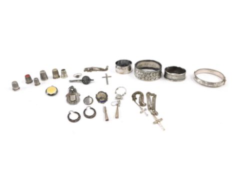 A group of silver and other jewellery, comprising two Victorian hinged bangles, silver thimbles, shield fob, chains, yellow e