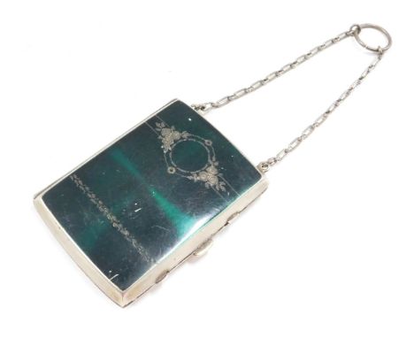 A stainless steel and enamel coin purse, the green enamel front with engine engraved decoration, opening to reveal two fitted