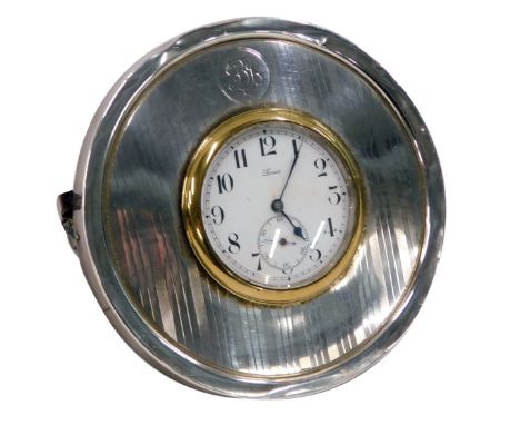 A George V silver framed circular mantel clock, engine engraved decoration and circular shield stamped BJ, with a white ename