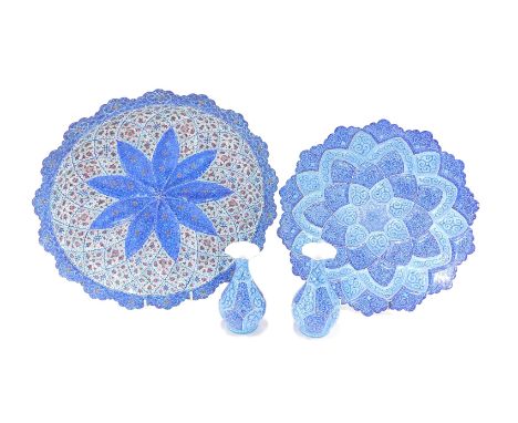 Middle Eastern enamel wares, comprising a charger and matching vases, on a dark and light blue ground, stamped Made in Iran o