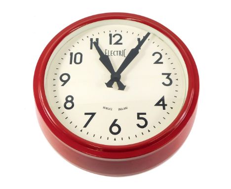 A red painted electric wall clock, stamped New Gate England, 37cm diameter. 