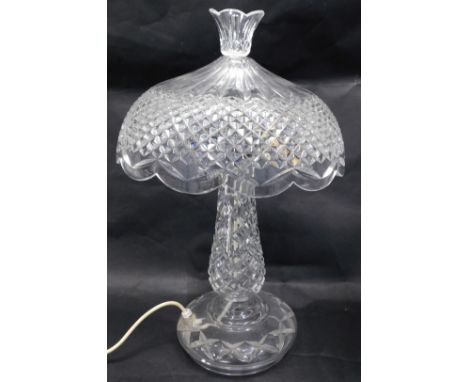 A 20thC pressed glass table lamp, the domed and fluted shade, on a shaped stem on circular foot, 44cm high. WARNING! This lot