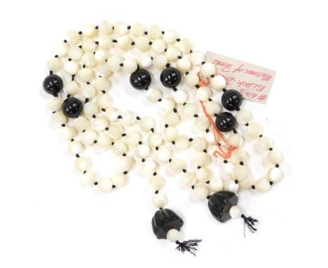 A Tulla Booth black jade and mother of pearl fashion necklace, with tassel strand decoration, 60cm long. 