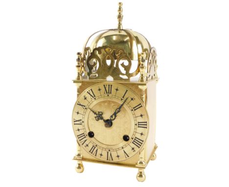 A brass lantern type mantel clock, the dial signed Lionel Peck, London, 24cm high. 