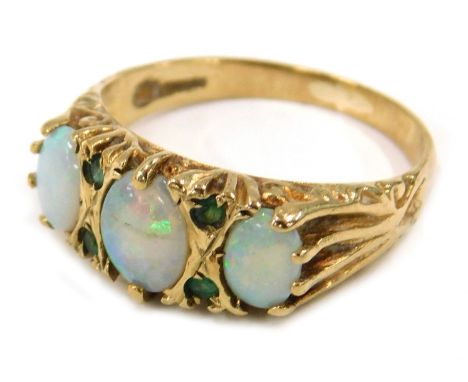 An 18ct gold opal and emerald dress ring, set with three oval opals and four round brilliant cut emeralds, each in claw setti