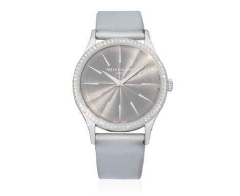 Patek Philippe. A fine lady's 18K white gold diamond set manual wind wristwatchModel: CalatravaReference: 4897G-010Date: Purc