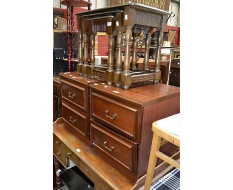 An Ercol style nest of three tables; two two drawer bedside cabinets; a glass and chrome TV stand; a contemporary centre thre