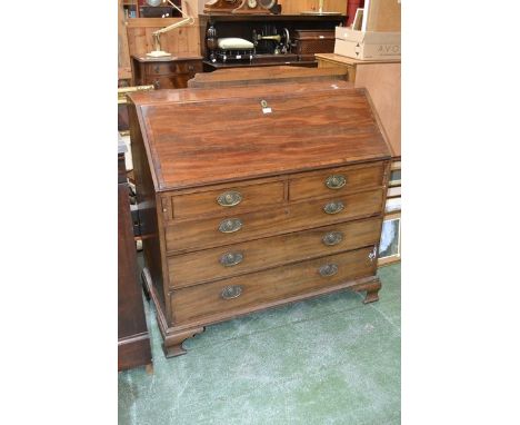 A George III mahogany bureau, fall front enclosing fitted interior above an arrangement of two short and three long drawers, 