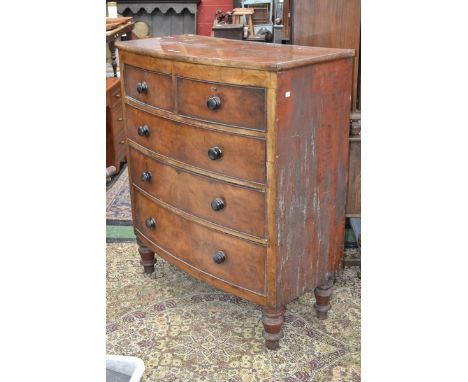A Victorian mahogany bowfront chest of two short cockbeaded drawers over three graduated long, turned handles and feet. 124cm