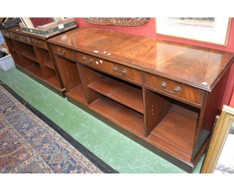 A pair of mahogany office side cabinets, fitted with three drawers over open cupboards, plinth bases