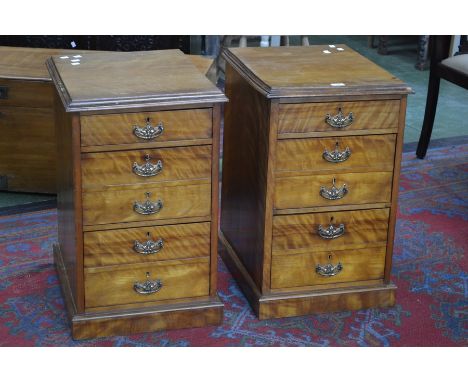 A pair of satinwood bedside chests of three graduated drawers, the second and third drawers with faux double drawer frontages