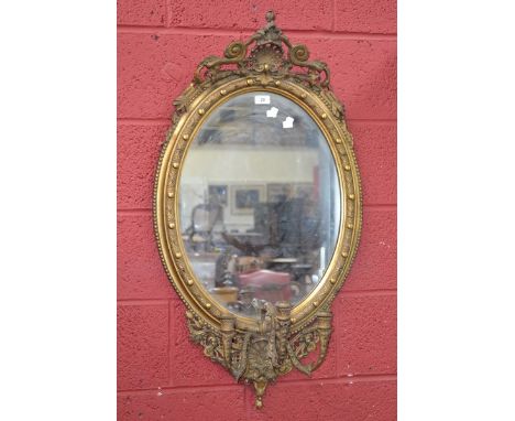 A three light oval gilt girandole mirror, 103cm x 56cm