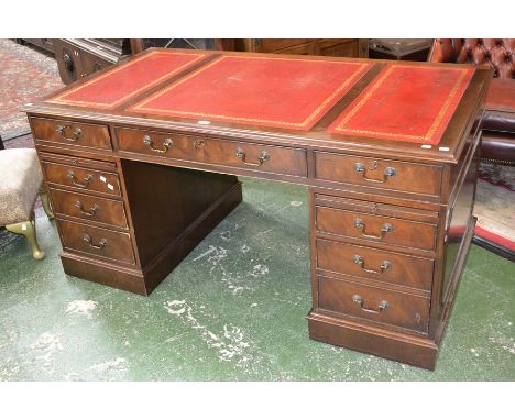 A 20th Century mahogany kneehole desk, fitted with three drawers, three to each pedestal and slide, tooled leather top, plint