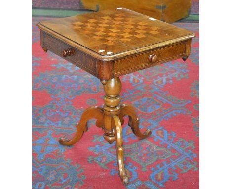 A Victorian mahogany games table, the top with chessboard, drawers and blind drawer to frieze, turned column, s. scroll tripo