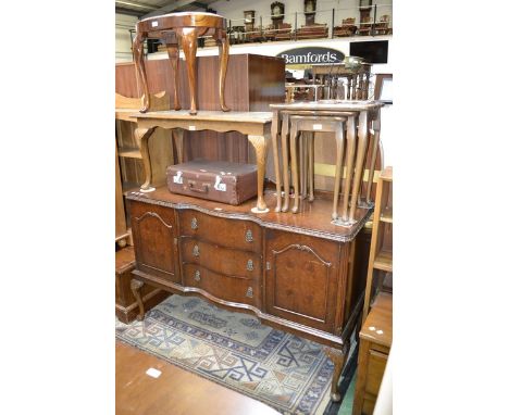 A reproduction walnut sideboard with serpentine drawers; walnut glass top coffee table; a reproduction burr walnut nest of ta