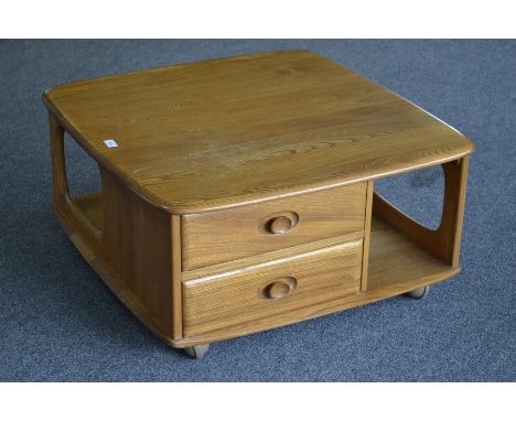 An Ercol elm coffee table, rounded square top, two short drawers, undertier. 40cm high x 80cm.