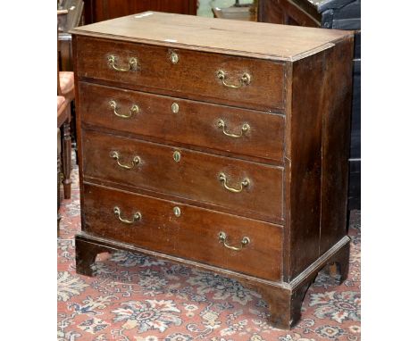 A George III oak chest of four long graduated drawers, brass swing handles, ogee feet. 92cm high x 88cm wide x 48cm deep.