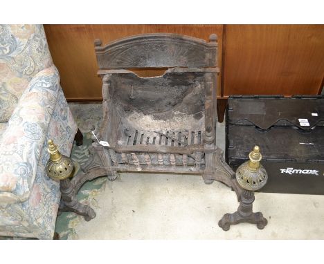 A George III cast iron fire grate, spindled basket, brass finials and mounts.