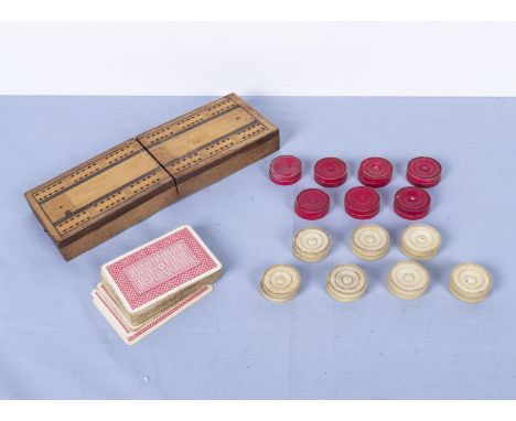 A vintage cribbage set together with fourteen bone draught pieces