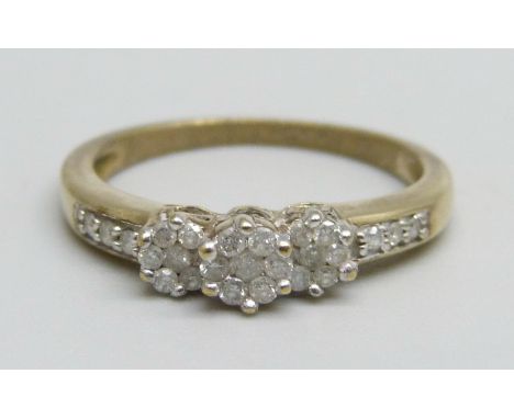 A 9ct gold ring set with three diamond clusters and diamond shoulders, 2.2g, O 