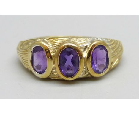 A silver gilt, three stone amethyst ring, T 