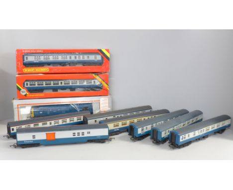 A collection of model rail including eight blue/grey coaches, and a blue diesel Intercity locomotive 