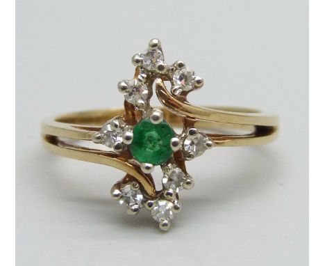 A yellow metal ring marked 10-14k, set with an emerald and eight diamonds, signed Bermark, 2.4g, M 