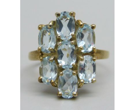 A silver gilt ring set with seven sky blue topaz stones, O 