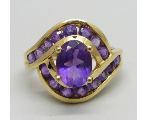 An 18ct gold, and amethyst set crossover ring, 5.1g, M/N 