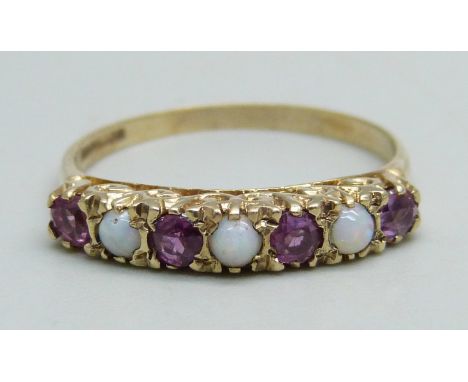 A 9ct gold ring set with three opals and four rubies, 2.5g, Q 