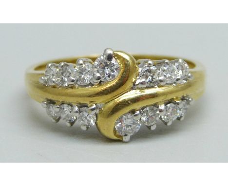 An 18ct gold ring set with 14 diamonds, 4.4g, P/Q 