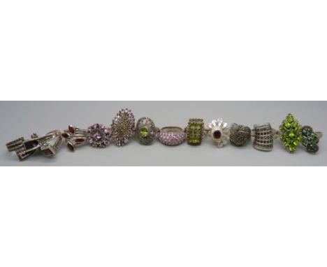 Twelve large chunky silver rings set with garnet, pearl and peridot, and one unmarked white metal ring, up to 35mm, 120g 