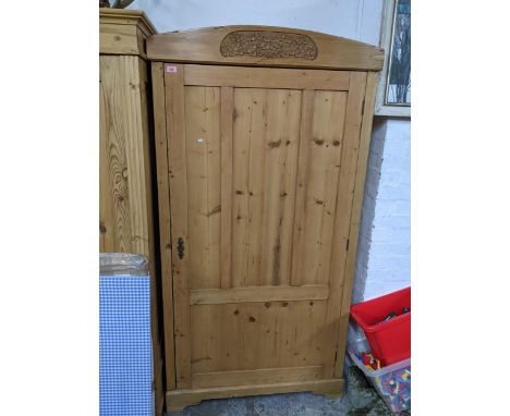 An Edwardian pine single door wardrobe with carved floral motif to pediment, standing on bracket feet 189cm x 97cm x 50cm Loc