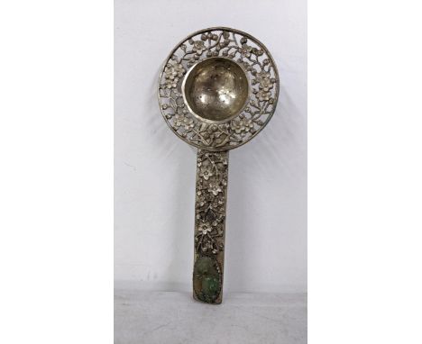 A Chinese white metal tea strainer with pierced floral decoration and inset with jade to the handleLocation: 