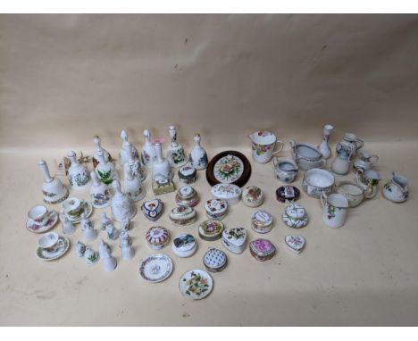 A group of porcelain collectables to include various pill boxes, porcelain bells, mini cups and saucers including Bramley Hed