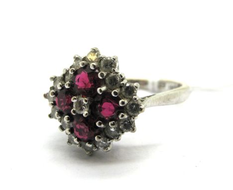 A Modern Ruby and Diamond Cluster Ring, graduated claw set throughout, stamped "18ct Plat".
