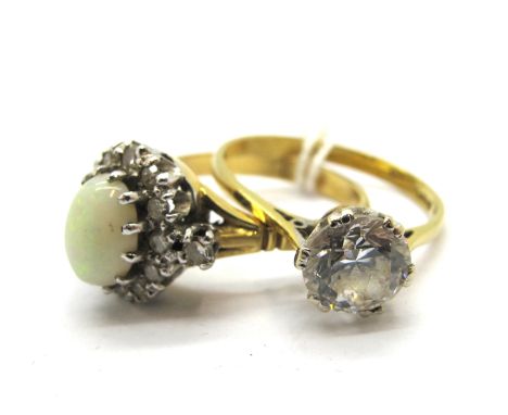 An 18ct Gold Opal and Diamond Set Cluster Ring, oval claw set to the centre, within border of single cut diamonds; An 18ct Go