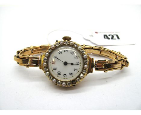 An 18ct Gold Diamond and Pearl Set Ladies Wristwatch, the white enamel dial with black and red Arabic numerals, within bezel 